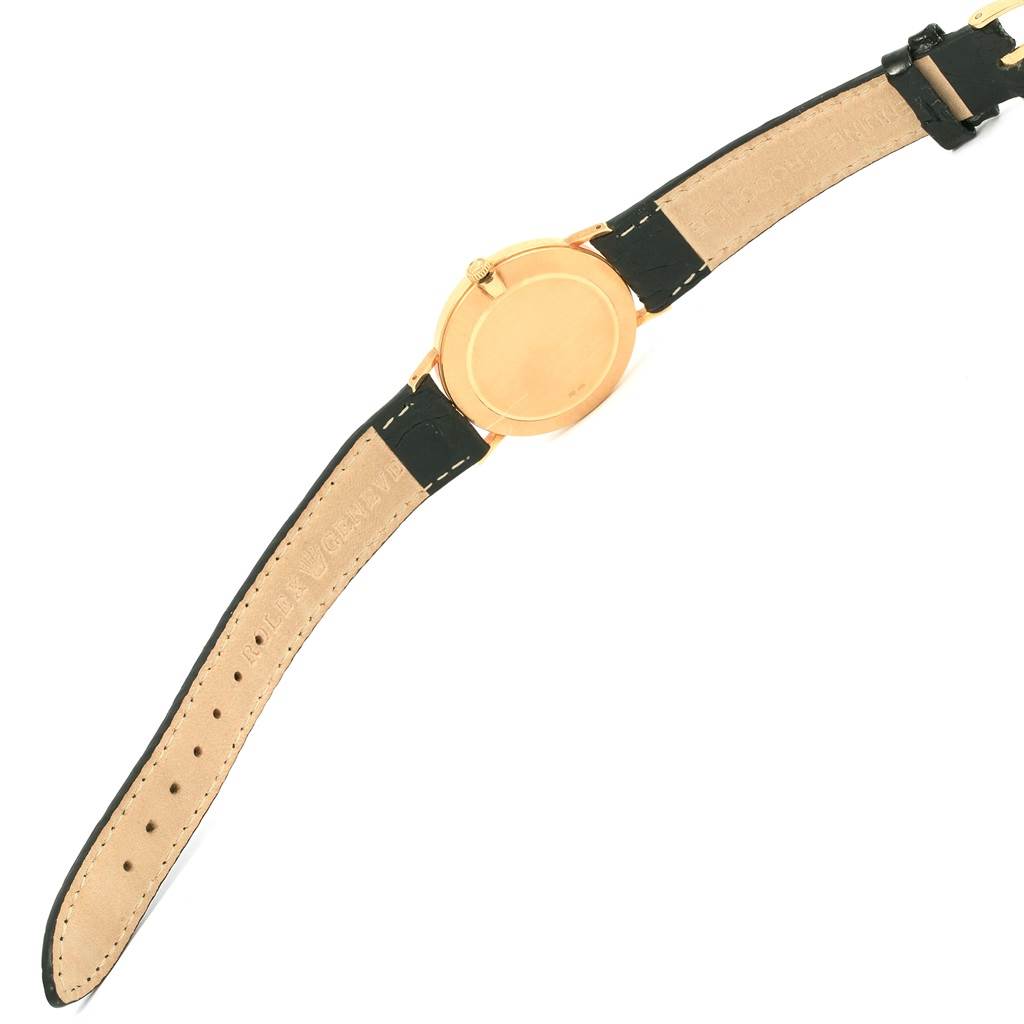 This image shows the back of a Rolex Cellini 4112 Yellow Gold Champagne Dial 4112 Yellow Gold Champagne Dial watch, including the case and leather straps.