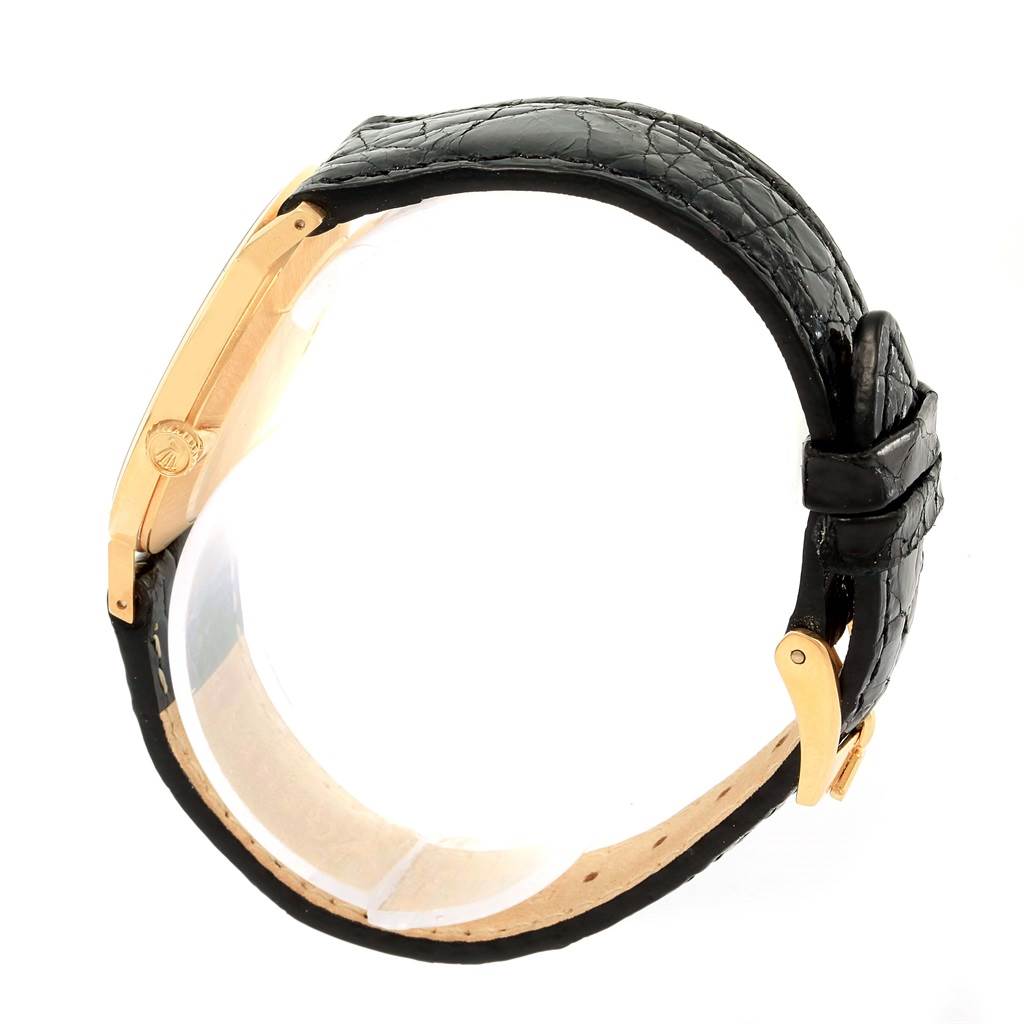 The Rolex Cellini 4112 Yellow Gold Champagne Dial 4112 Yellow Gold Champagne Dial watch is shown from a side angle, highlighting the gold case and black leather strap with buckle.