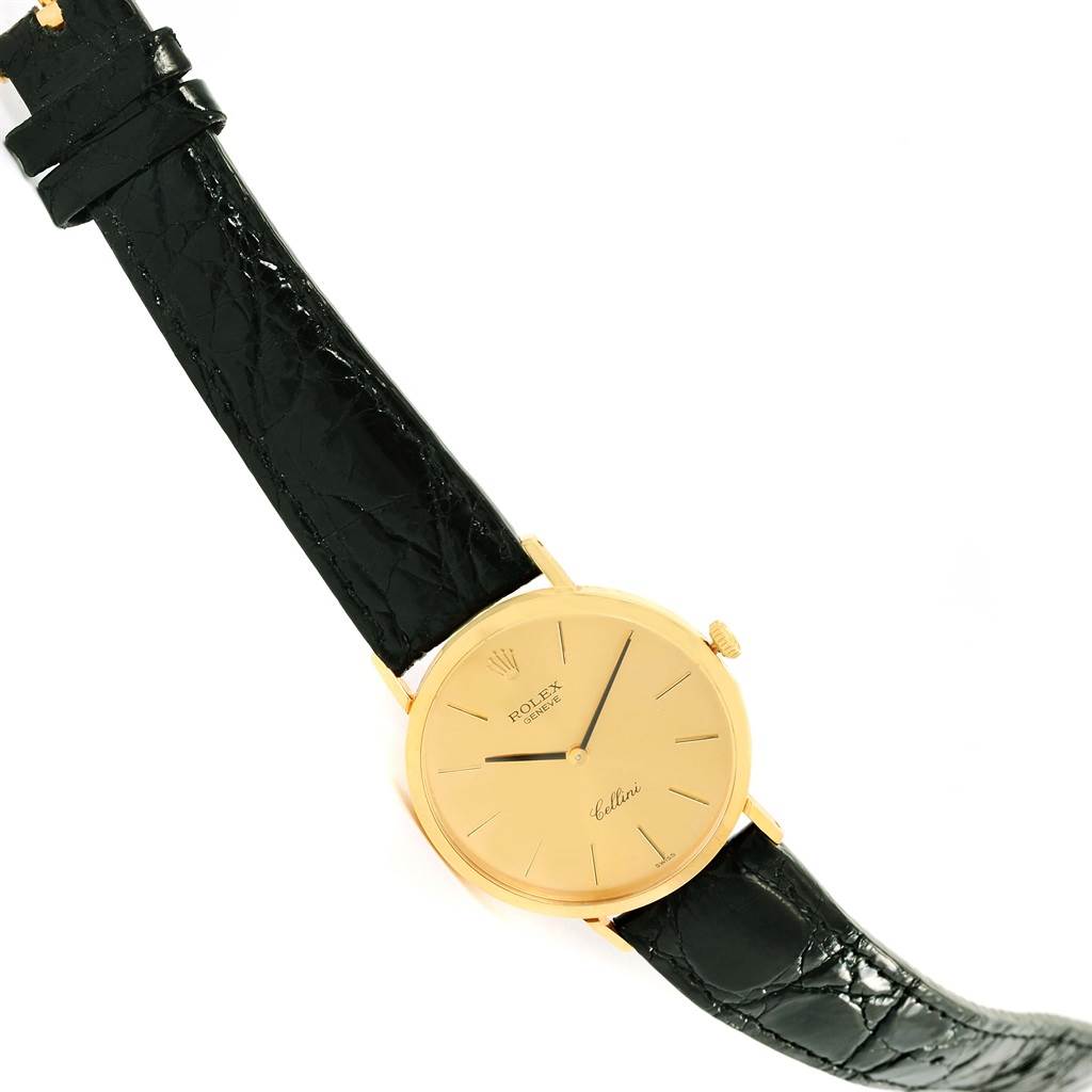 The image shows a Rolex Cellini 4112 Yellow Gold Champagne Dial 4112 Yellow Gold Champagne Dial watch at a slight diagonal angle, highlighting its gold face, black leather strap, and crown.
