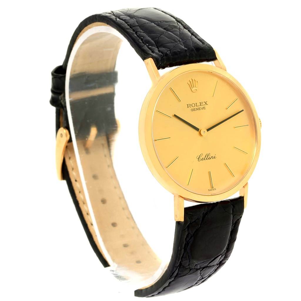 The Rolex Cellini 4112 Yellow Gold Champagne Dial 4112 Yellow Gold Champagne Dial watch is displayed at a three-quarter angle, showcasing its black leather strap and gold dial.
