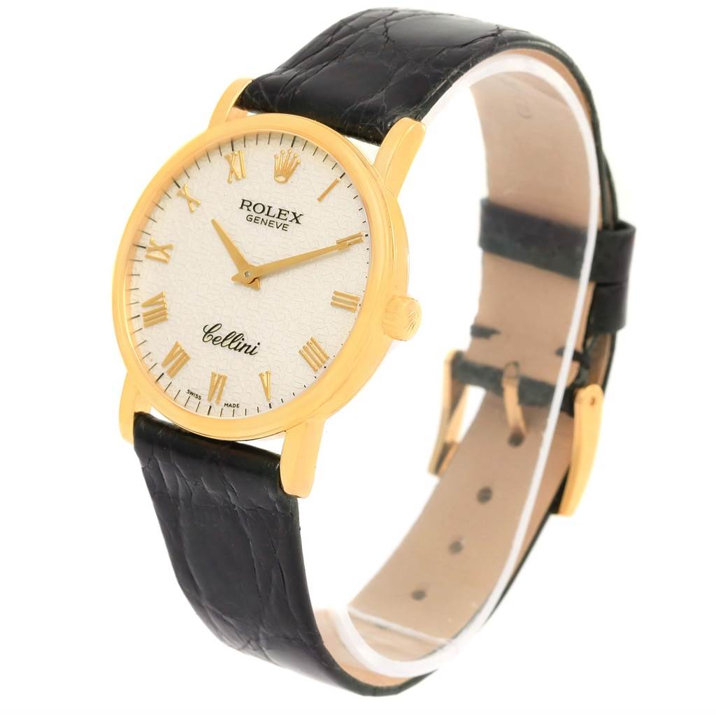 The Rolex Cellini 5115 Yellow Gold Beige Dial 5115 Yellow Gold Beige Dial watch is shown at an angled side view, highlighting the face, dial, crown, and leather strap.