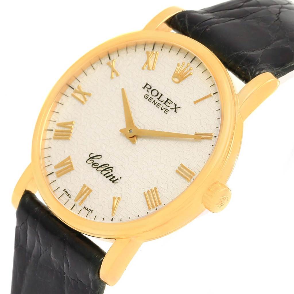 The Rolex Cellini 5115 Yellow Gold Beige Dial 5115 Yellow Gold Beige Dial watch is shown at an angled view, highlighting the face, case, crown, and part of the leather strap.