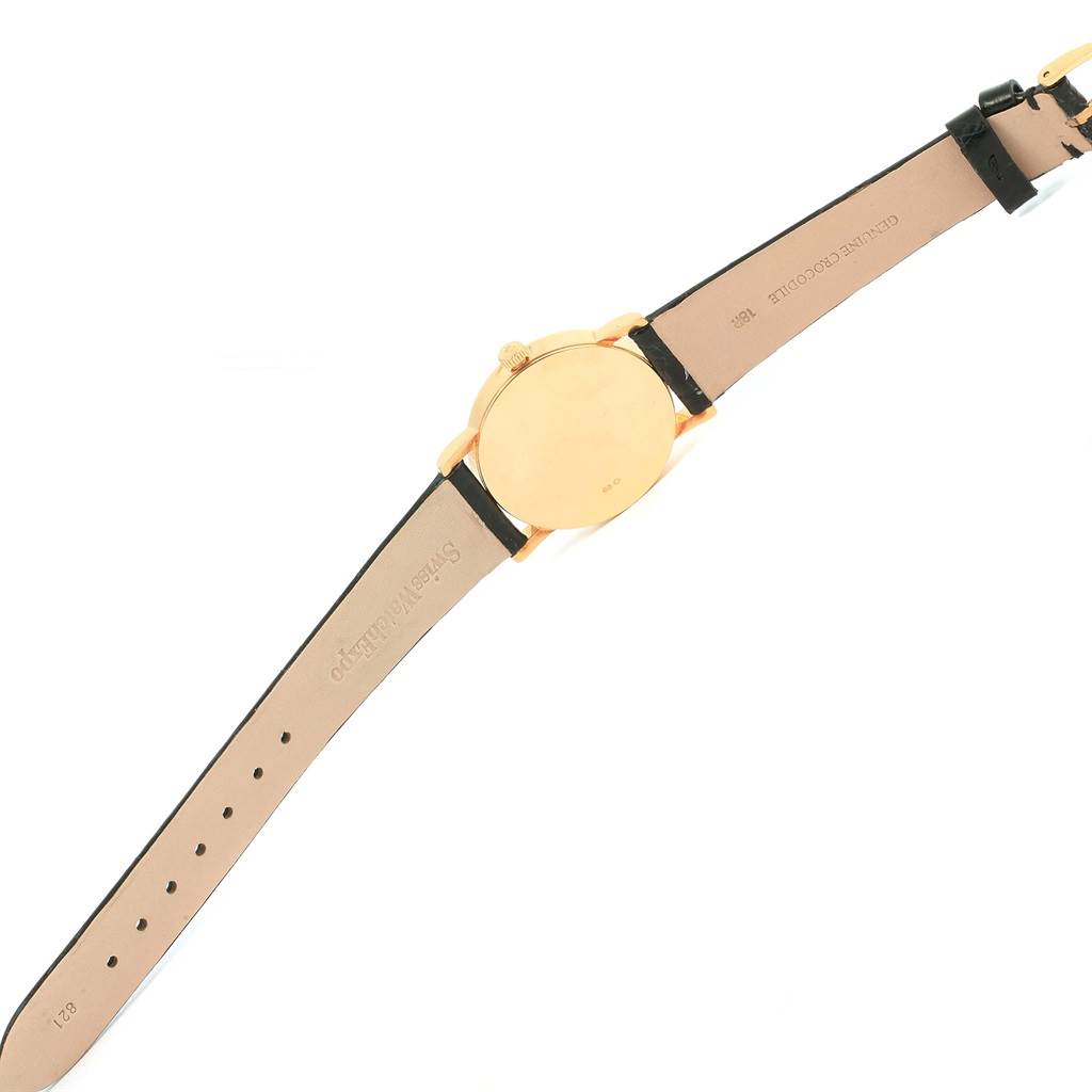 The image shows the back of a Rolex Cellini 5115 Yellow Gold Beige Dial 5115 Yellow Gold Beige Dial watch, displaying its leather strap and gold case from a top-down angle.