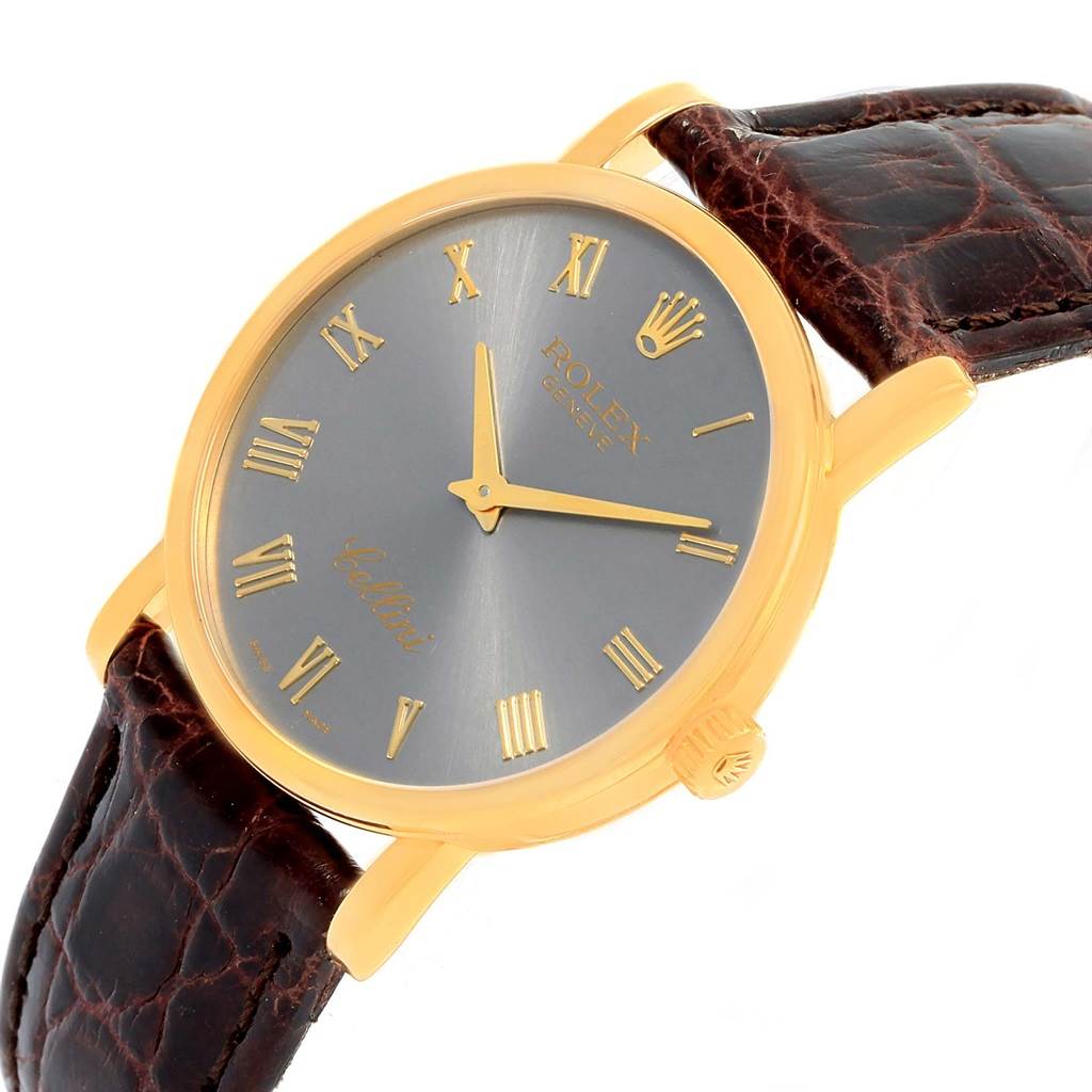 The image shows a Rolex Cellini 5115 Men's Yellow Gold Grey Dial 5115 Men's Yellow Gold Grey Dial watch at a three-quarter angle, highlighting the gold case, gray dial, and brown leather strap.