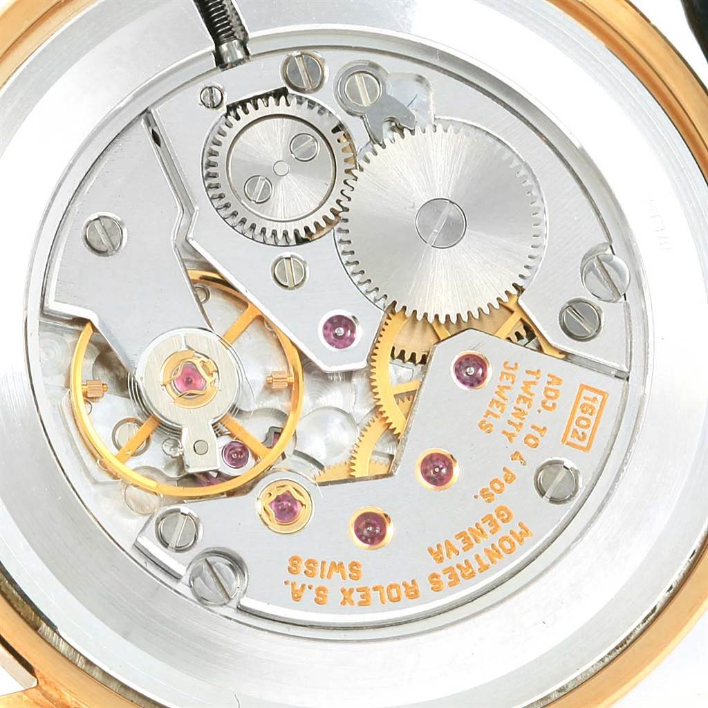 This image shows a close-up view of the inner mechanical movement of the Rolex Cellini 4112 Men's Yellow Gold Beige Dial 4112 Men's Yellow Gold Beige Dial watch, highlighting gears and jewels.
