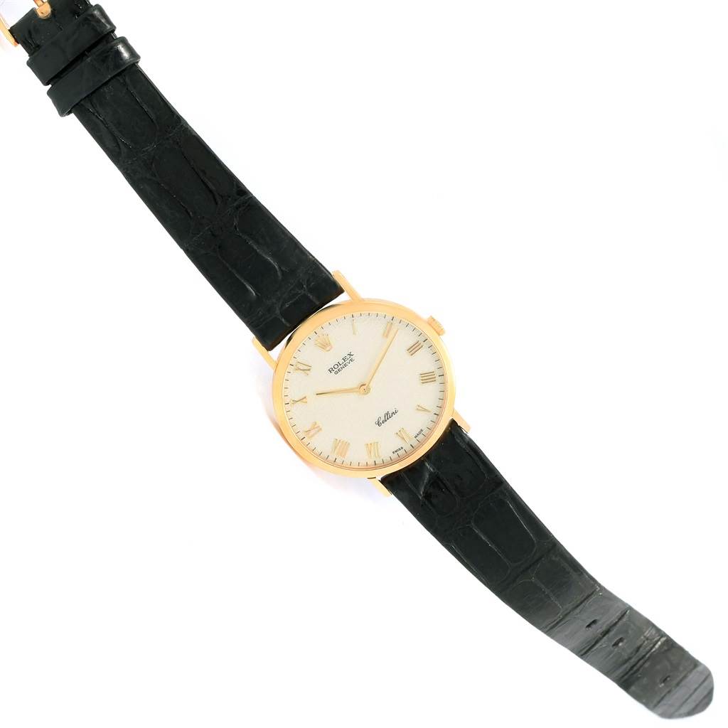 The image shows a Rolex Cellini 4112 Men's Yellow Gold Beige Dial 4112 Men's Yellow Gold Beige Dial watch with a gold case, white dial, and black leather strap from a top-down angle.