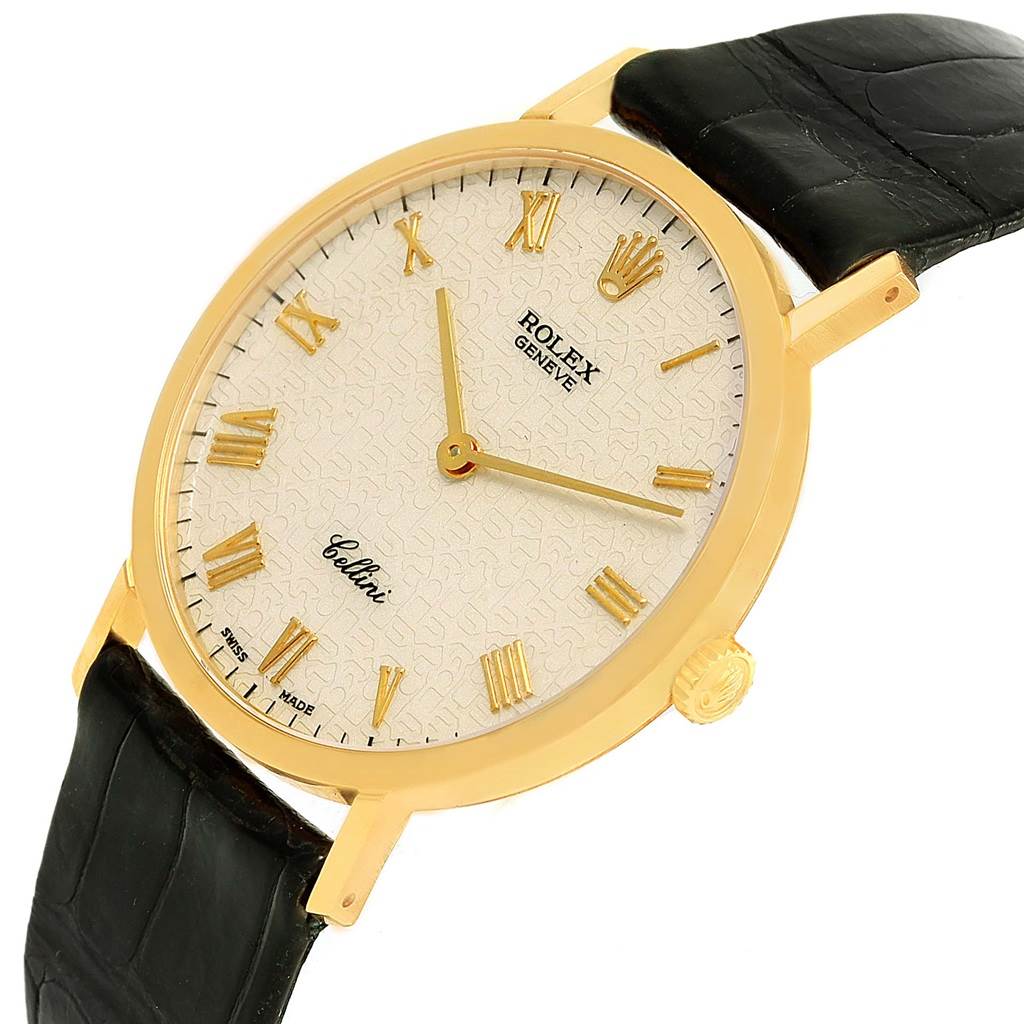 The Rolex Cellini 4112 Men's Yellow Gold Beige Dial 4112 Men's Yellow Gold Beige Dial watch is shown at an angled view, highlighting its dial, gold case, crown, and black leather strap.