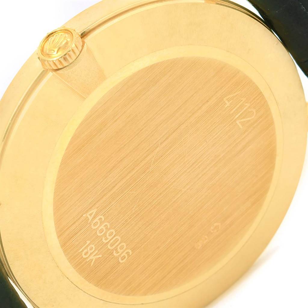 The image shows the back case of a Rolex Cellini 4112 Men's Yellow Gold Beige Dial 4112 Men's Yellow Gold Beige Dial watch, highlighting its 18K gold material and inscriptions, including the crown logo.