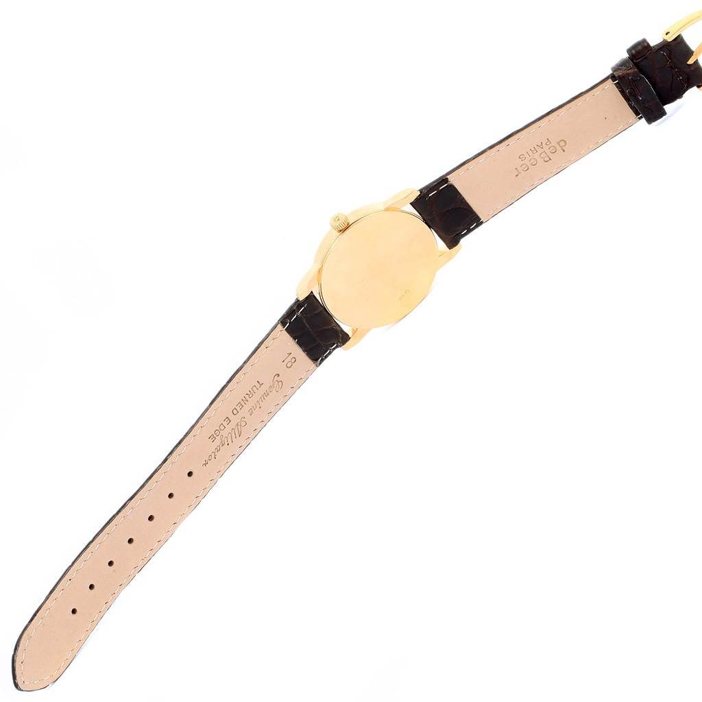 The image shows the back view of a Rolex Cellini 5116 Men's Yellow Gold Champagne Dial 5116 Men's Yellow Gold Champagne Dial model watch, including its leather strap and case back.