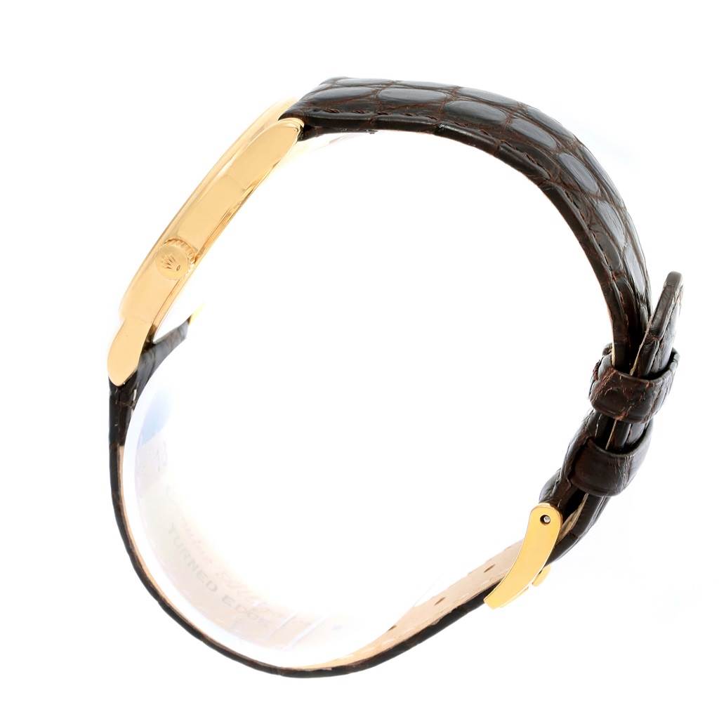 The image shows a side view of a Rolex Cellini 5116 Men's Yellow Gold Champagne Dial 5116 Men's Yellow Gold Champagne Dial watch, highlighting the leather strap and gold case.