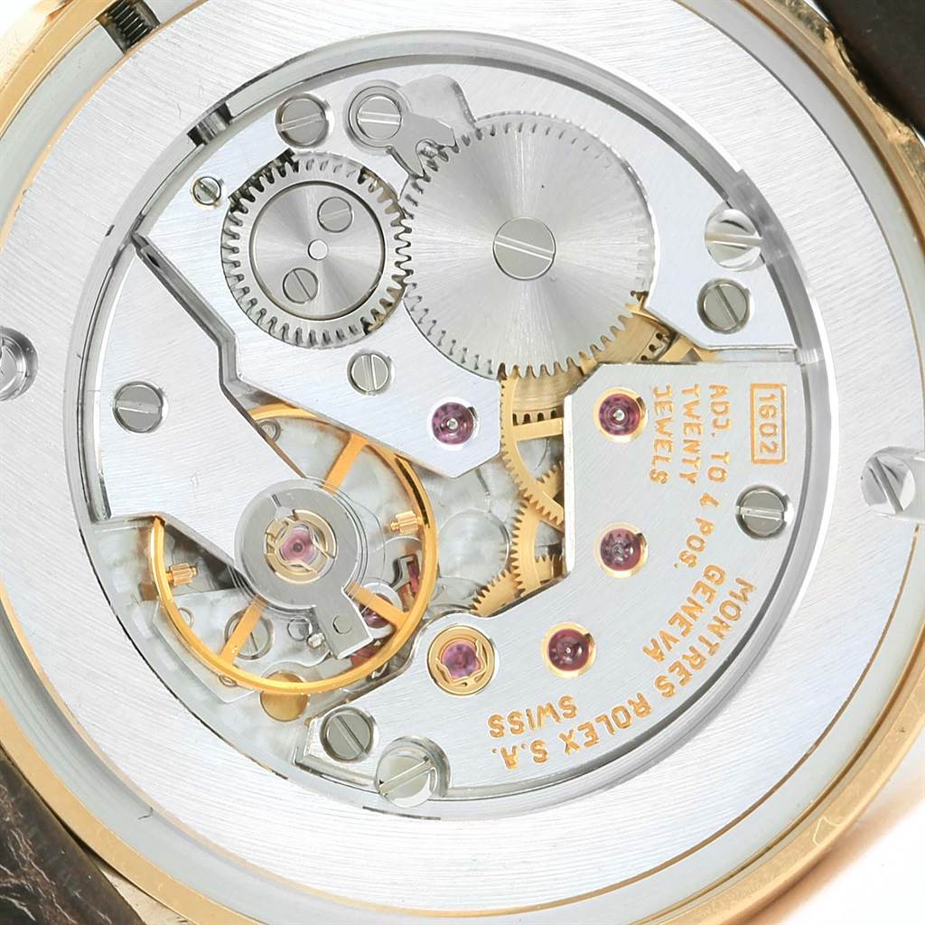 This is a close-up of the internal mechanisms of a Rolex Cellini 5116 Men's Yellow Gold Champagne Dial 5116 Men's Yellow Gold Champagne Dial watch, showcasing its gears and movement components.