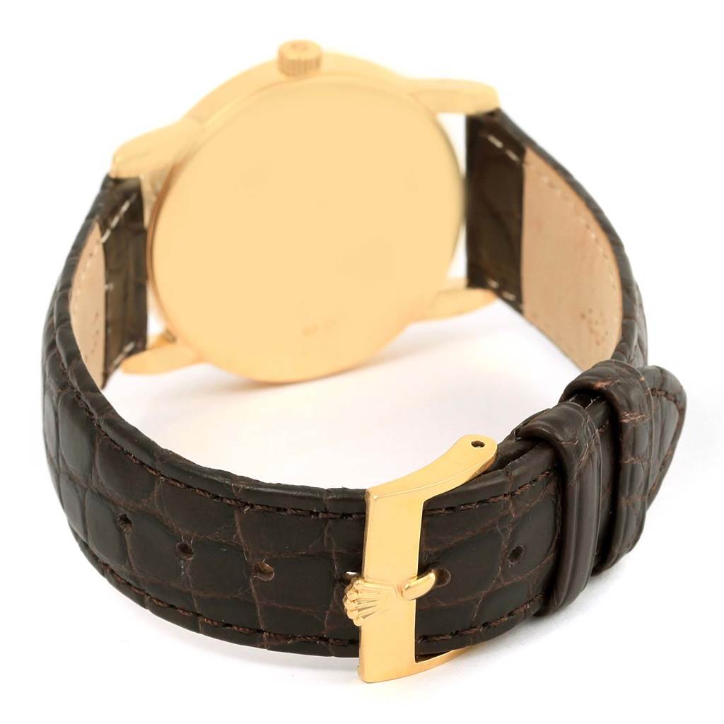 The Rolex Cellini 5116 Men's Yellow Gold Champagne Dial 5116 Men's Yellow Gold Champagne Dial watch is shown from the back, highlighting its leather strap and gold buckle.