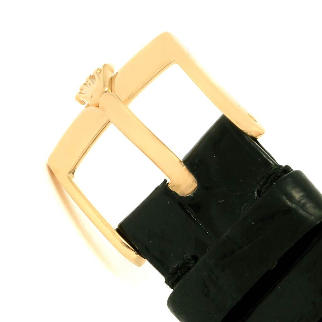 This image shows a close-up of the buckle and part of the leather strap of a Rolex Cellini 4112 Men's Yellow Gold Grey Dial 4112 Men's Yellow Gold Grey Dial watch.