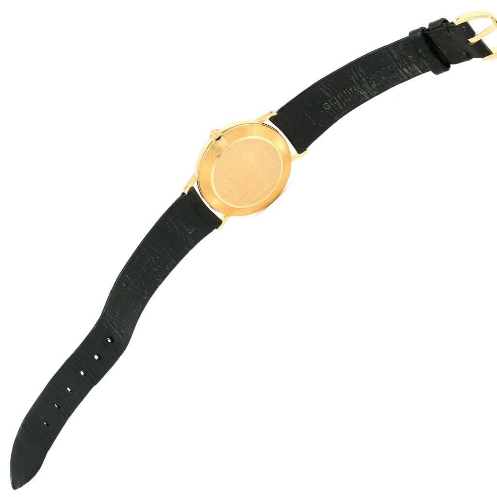 The image shows the back view of a Rolex Cellini 4112 Men's Yellow Gold Grey Dial 4112 Men's Yellow Gold Grey Dial model watch, highlighting its black leather strap and gold case.