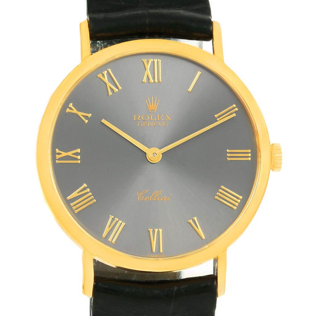 The Rolex Cellini 4112 Men's Yellow Gold Grey Dial 4112 Men's Yellow Gold Grey Dial watch is shown from a front angle, displaying its round dial with gold Roman numerals and black leather strap.
