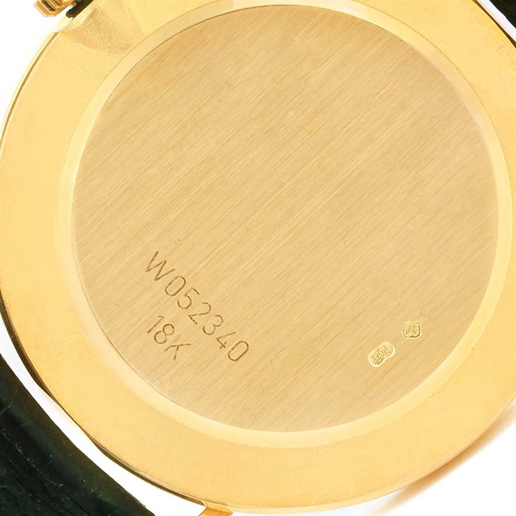The image shows the gold case back of a Rolex Cellini 4112 Men's Yellow Gold Grey Dial 4112 Men's Yellow Gold Grey Dial watch, displaying its serial number "W052340" and "18K" hallmark.