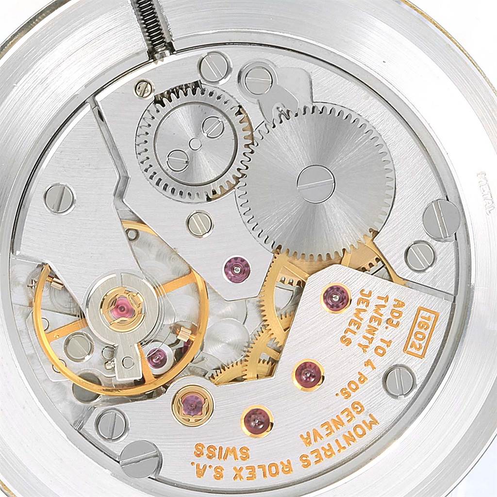 This image shows a close-up view of the movement mechanism of a Rolex Cellini 4112 Men's Yellow Gold Grey Dial 4112 Men's Yellow Gold Grey Dial watch, highlighting gears and jeweled components.