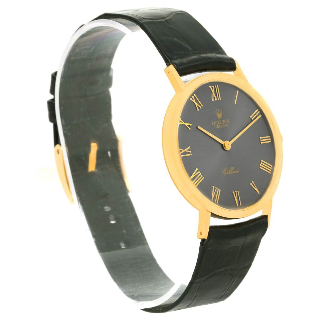 The Rolex Cellini 4112 Men's Yellow Gold Grey Dial 4112 Men's Yellow Gold Grey Dial watch is shown at a slight angle, displaying its black leather strap, gold case, and black dial with Roman numerals.