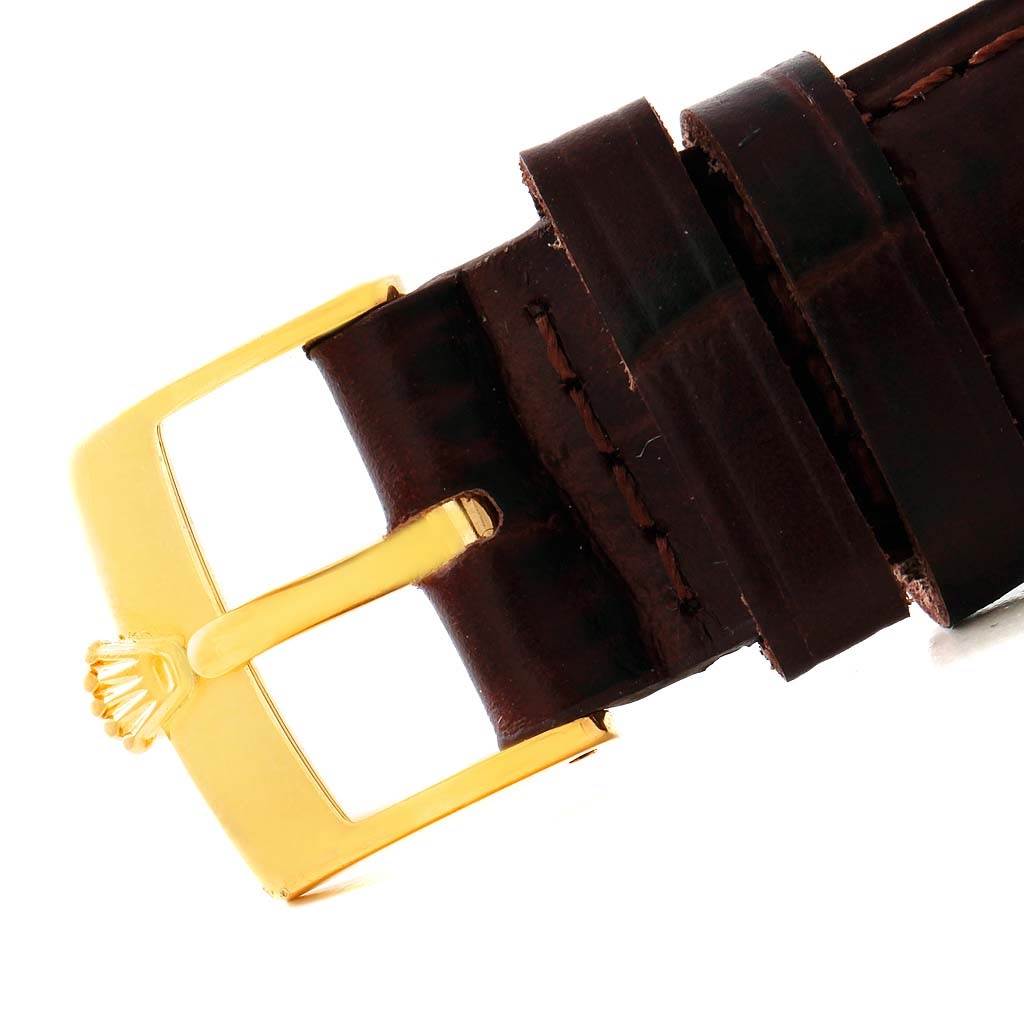 This image shows a close-up of a leather strap and gold buckle of a Rolex Cellini 5116 Men's Yellow Gold Beige Dial 5116 Men's Yellow Gold Beige Dial watch.