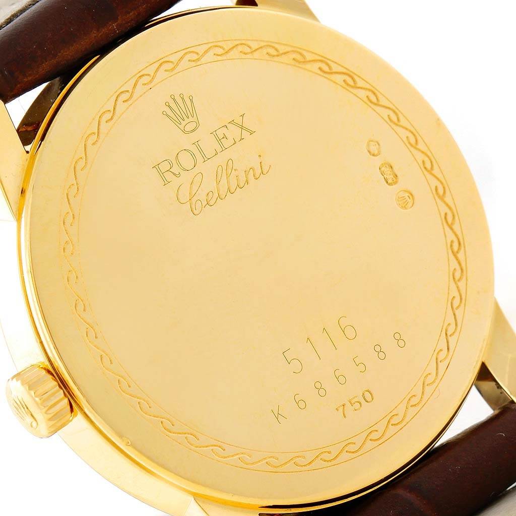 This image shows the rear casing and crown of a gold Rolex Cellini 5116 Men's Yellow Gold Beige Dial 5116 Men's Yellow Gold Beige Dial watch, displaying its engravings and serial number.