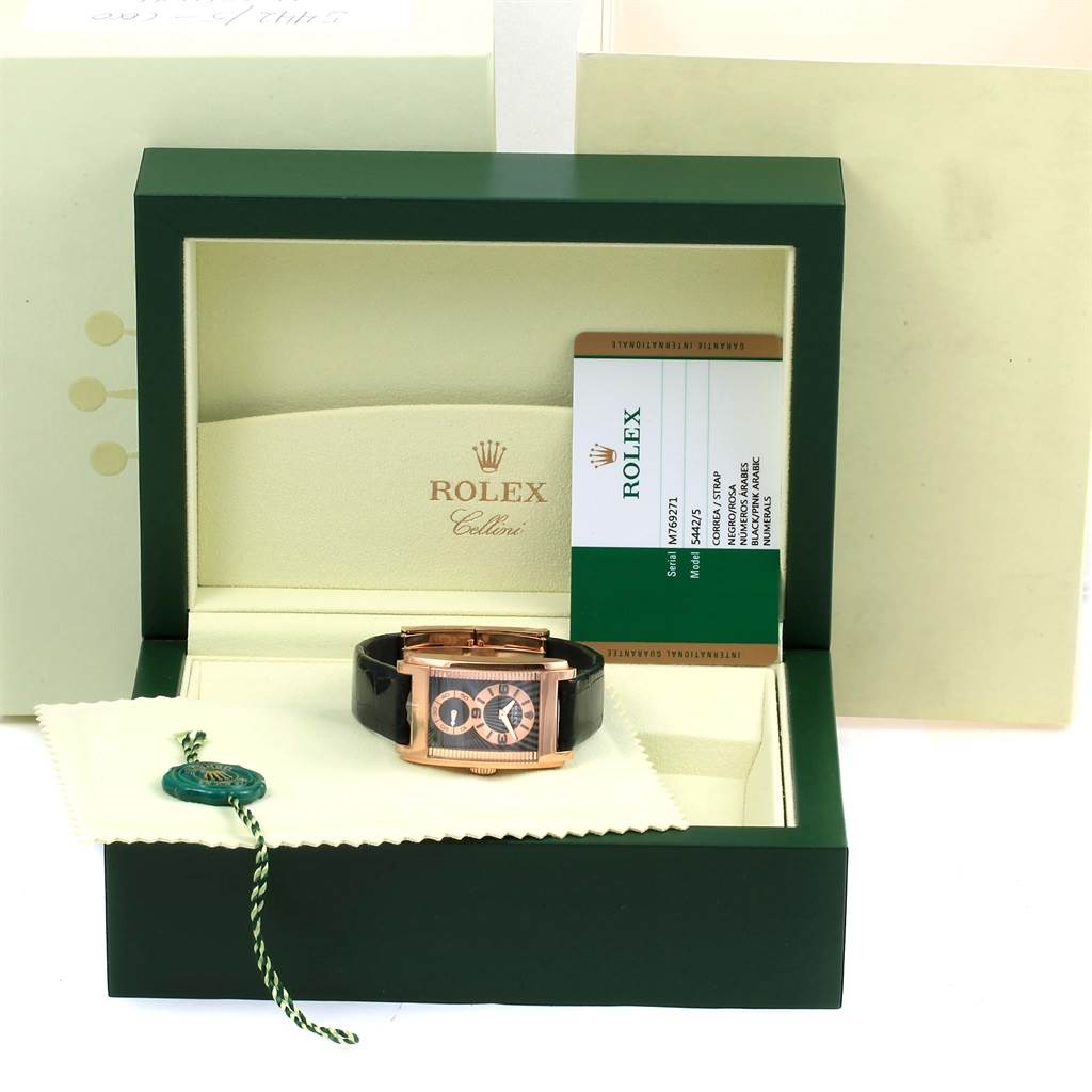 The Rolex Cellini 5442 Men's Rose Gold Black Dial 5442 Men's Rose Gold Black Dial watch is shown front-on in an open green box, accompanied by tags and paperwork, highlighting its packaging.