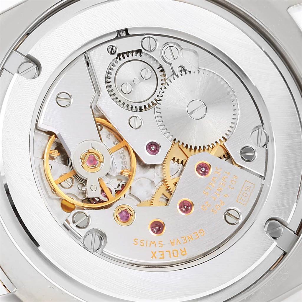 This is a close-up image of the movement mechanism in a Rolex Cellini 4233 Men's White Gold Black Dial 4233 Men's White Gold Black Dial watch, showing gears, screws, and jewels.