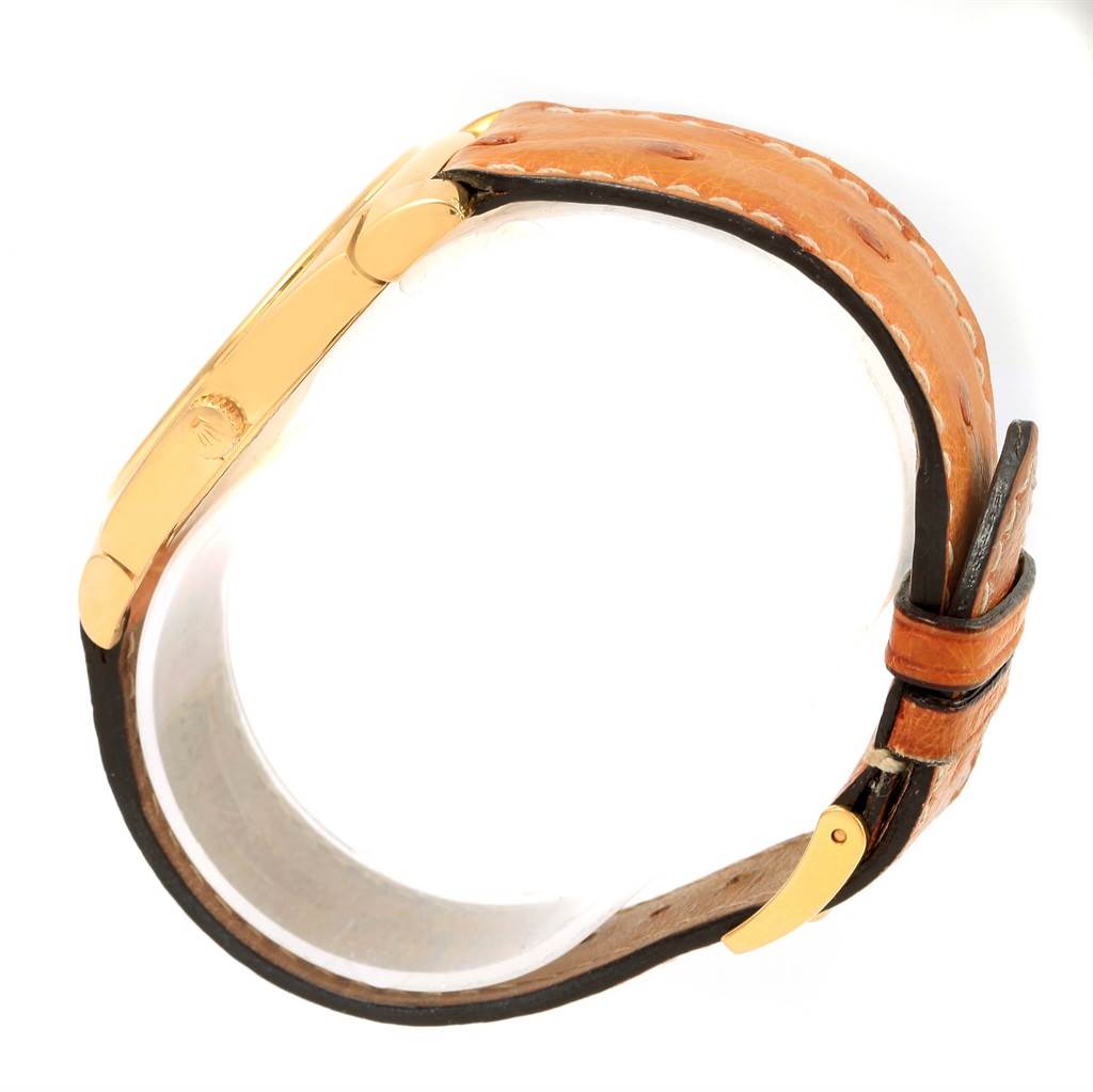 This image shows a profile view of the Rolex Cellini 5330 Men's Yellow Gold White Dial 5330 Men's Yellow Gold White Dial watch, focusing on its leather strap and gold side case with a visible crown logo.