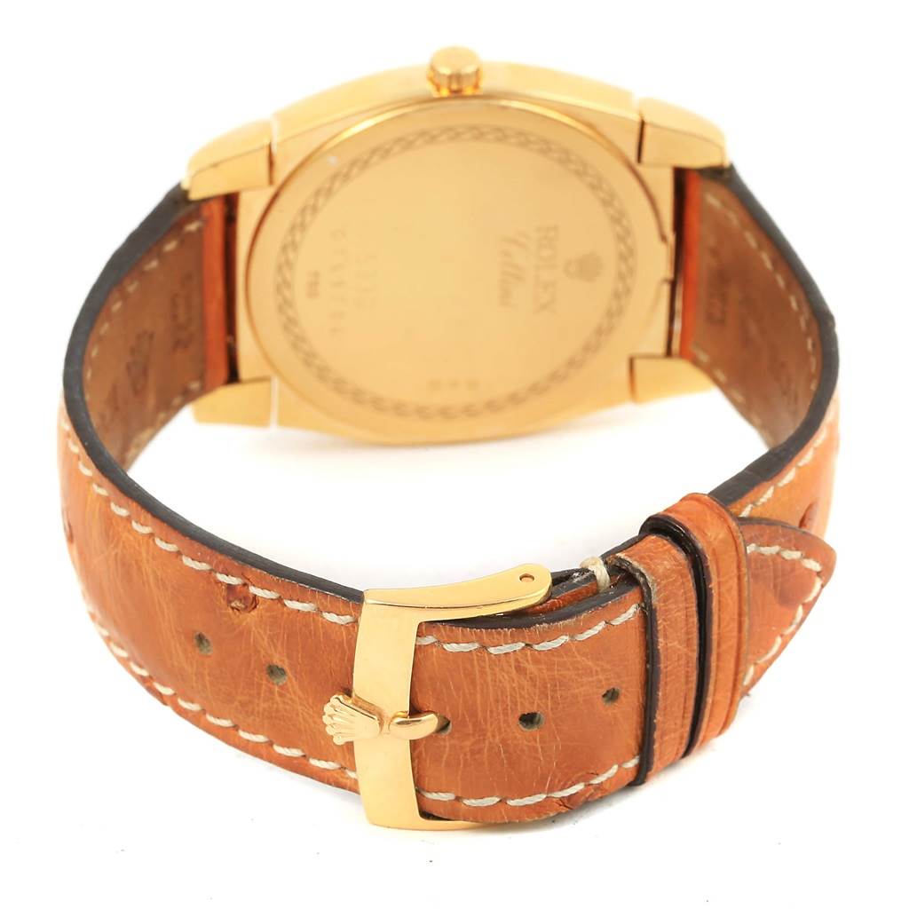 The image shows the back of a Rolex Cellini 5330 Men's Yellow Gold White Dial 5330 Men's Yellow Gold White Dial watch, focusing on its gold case, brown leather strap, and buckle.