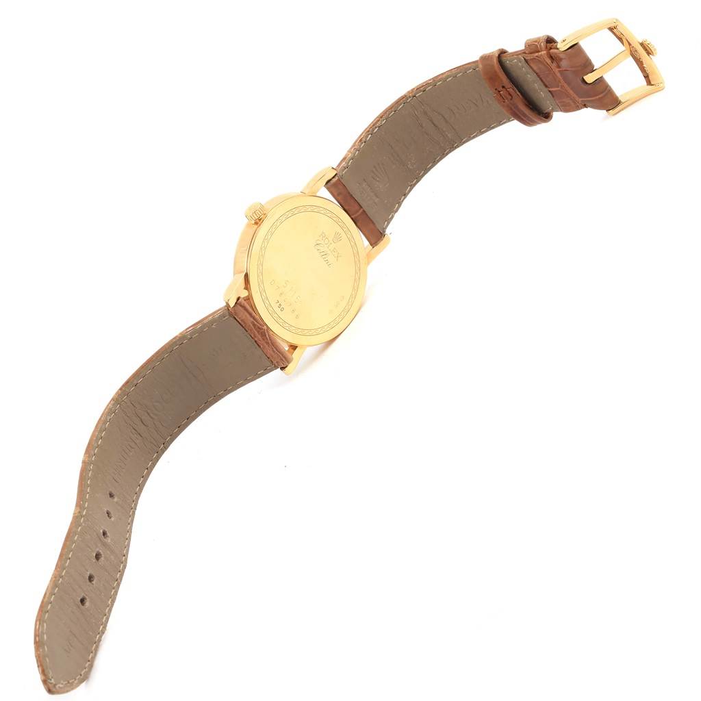 The image shows the backside and leather strap of a Rolex Cellini 5115 Yellow Gold Mother of Pearl Dial 5115 Yellow Gold Mother of Pearl Dial model watch at an angled view.