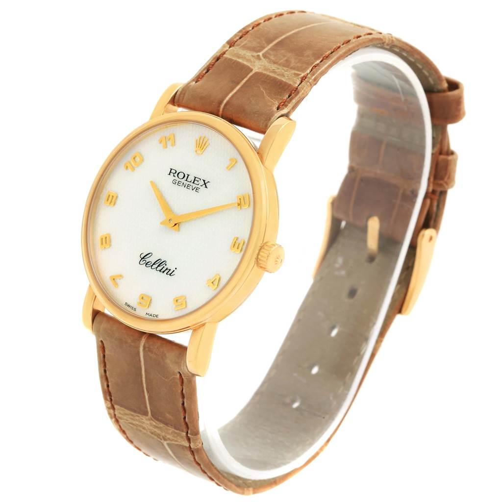 The image shows a Rolex Cellini 5115 Yellow Gold Mother of Pearl Dial 5115 Yellow Gold Mother of Pearl Dial watch at an angle, displaying its face, crown, and leather strap.