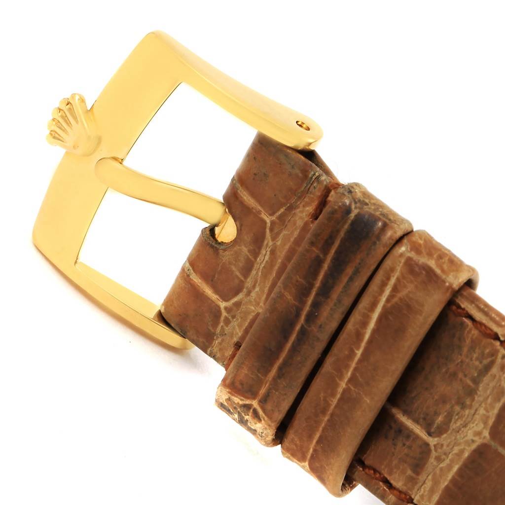The image shows the buckle and a portion of the leather strap of a Rolex Cellini 5115 Yellow Gold Mother of Pearl Dial 5115 Yellow Gold Mother of Pearl Dial watch.