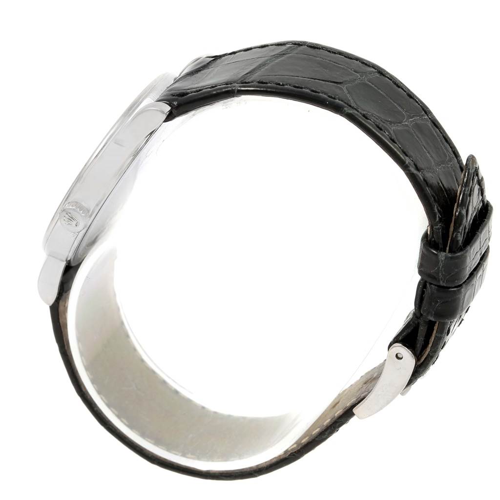 This Rolex Cellini 5115 White Gold Silver Dial 5115 White Gold Silver Dial watch is shown from a side angle, highlighting its black leather strap and silver buckle.