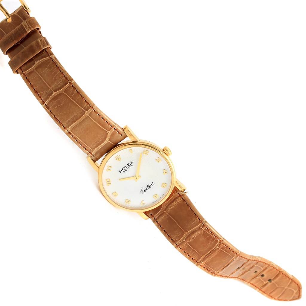 The image shows a full view of a Rolex Cellini 5115 Yellow Gold Mother of Pearl Dial 5115 Yellow Gold Mother of Pearl Dial watch with a brown leather strap, gold casing, and white dial.