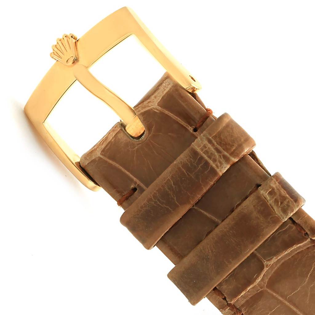 This image shows a close-up of the buckle and part of the leather strap of a Rolex Cellini 5115 Yellow Gold Mother of Pearl Dial 5115 Yellow Gold Mother of Pearl Dial watch.