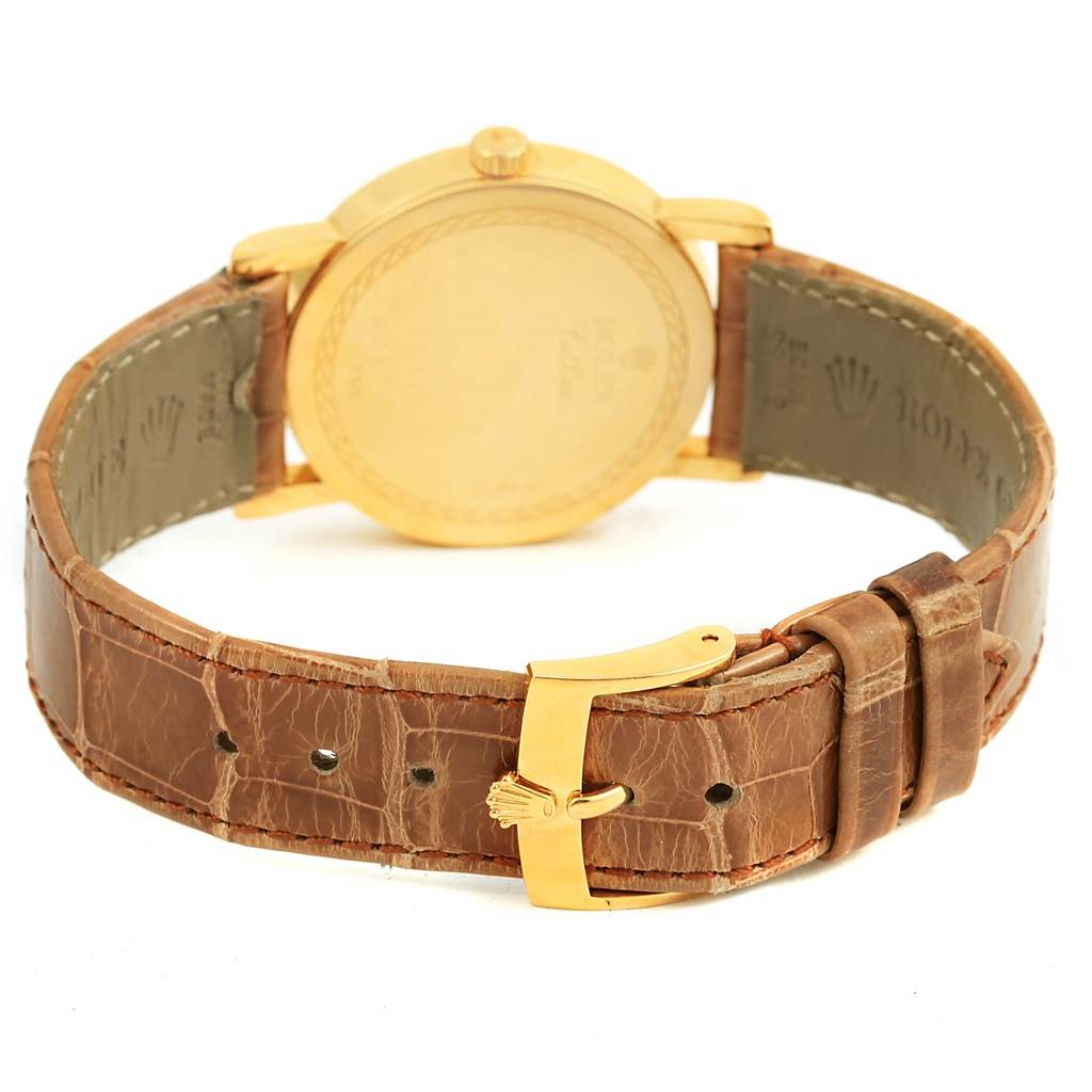 The image shows the back view of a Rolex Cellini 5115 Yellow Gold Mother of Pearl Dial 5115 Yellow Gold Mother of Pearl Dial watch, highlighting the case back, crown, and leather strap with a gold clasp.