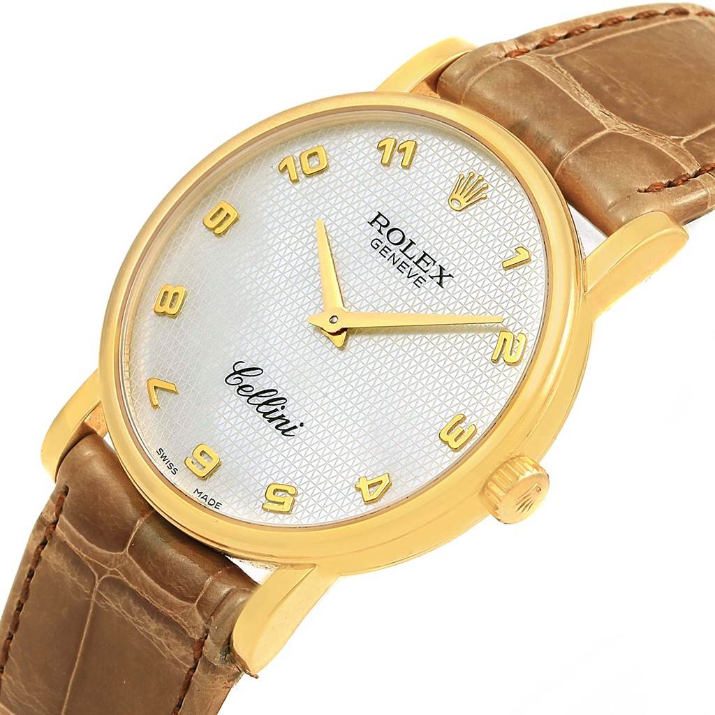 The image shows a Rolex Cellini 5115 Yellow Gold Mother of Pearl Dial 5115 Yellow Gold Mother of Pearl Dial watch from a close-up angle, highlighting its gold case, white dial, gold numerals, and brown leather strap.