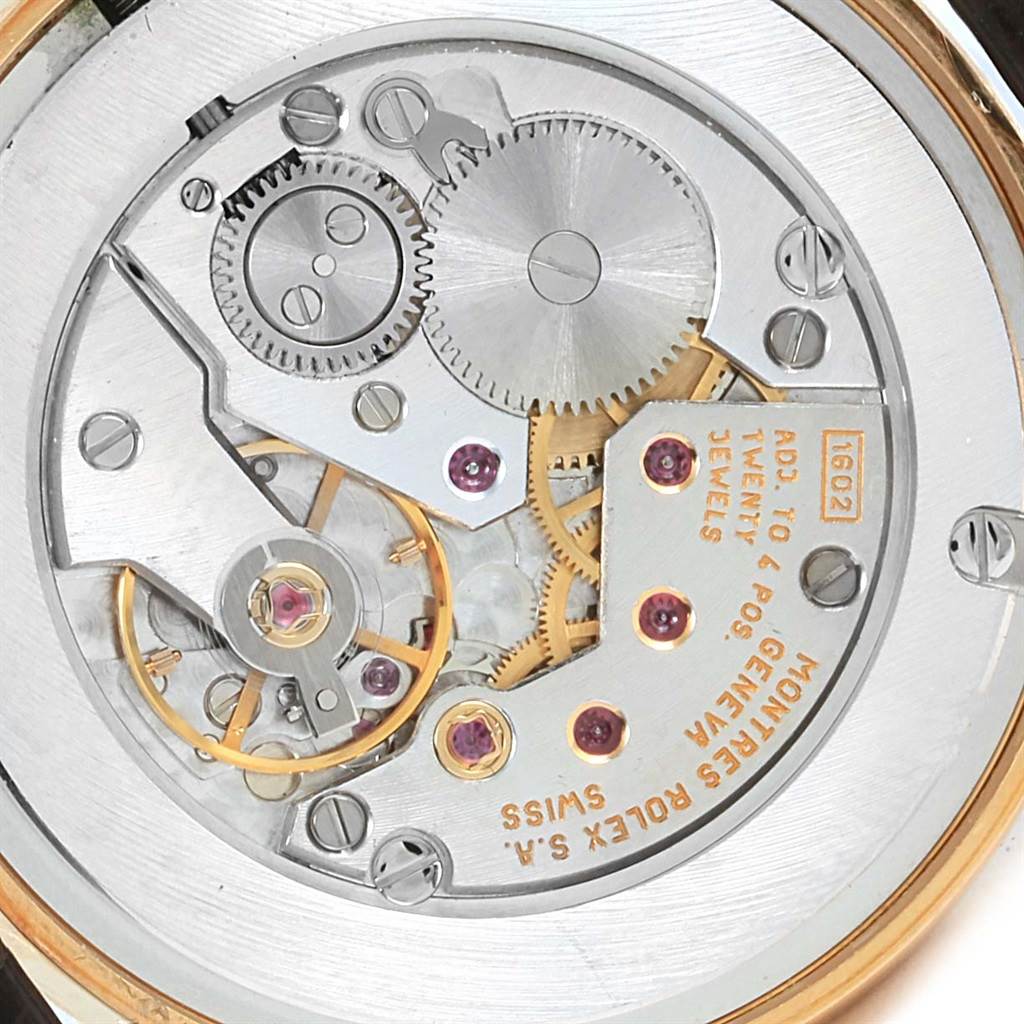 This close-up image shows the intricate mechanics of a Rolex Cellini 5116 Men's Yellow Gold Beige Dial 5116 Men's Yellow Gold Beige Dial watch movement.