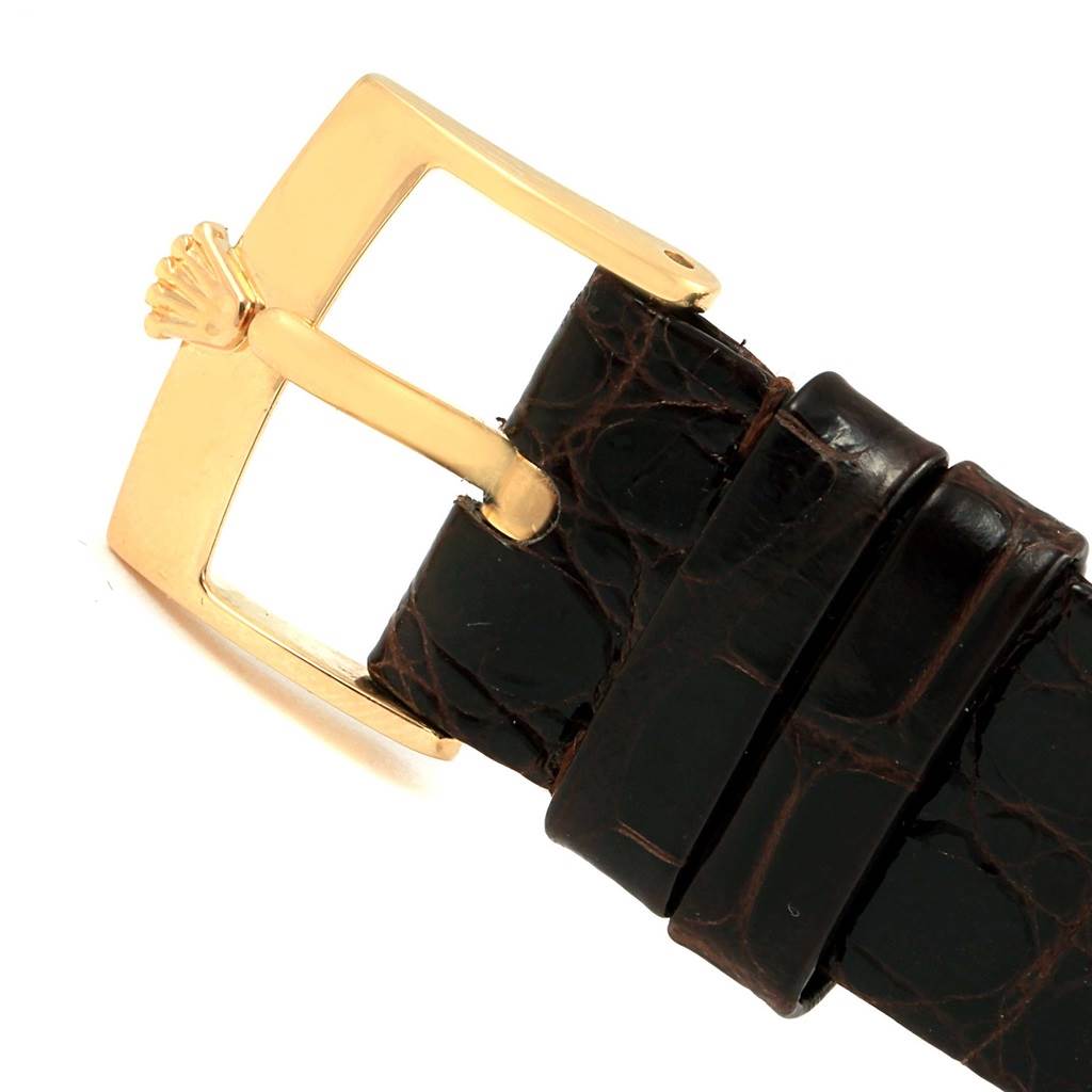 This image shows a close-up of the gold buckle and brown leather strap of a Rolex Cellini 5116 Men's Yellow Gold Beige Dial 5116 Men's Yellow Gold Beige Dial watch.