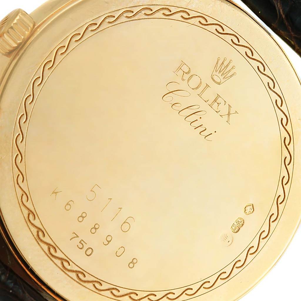 The image shows the back case of the Rolex Cellini 5116 Men's Yellow Gold Beige Dial 5116 Men's Yellow Gold Beige Dial model watch, displaying its inscriptions and intricate design.