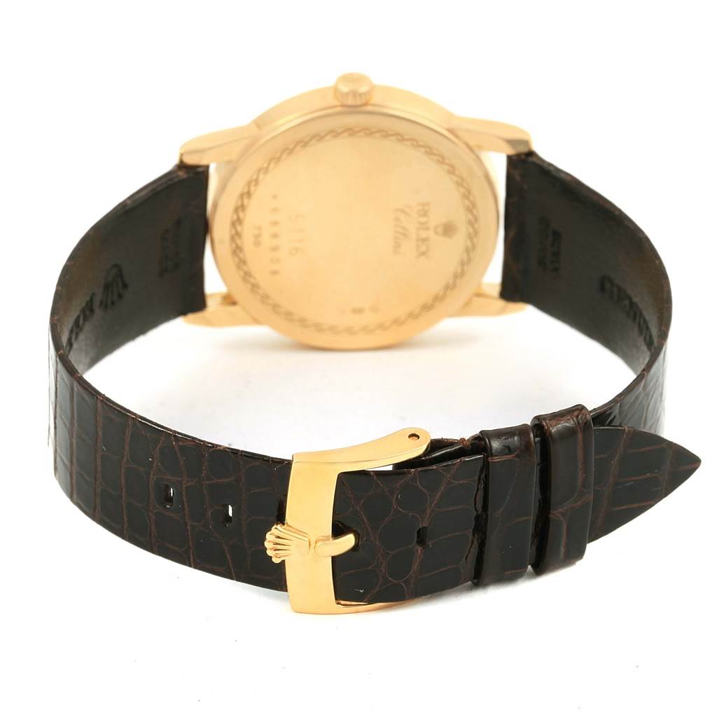 The image shows the back view of a Rolex Cellini 5116 Men's Yellow Gold Beige Dial 5116 Men's Yellow Gold Beige Dial watch, highlighting the case back, leather strap, and gold buckle.