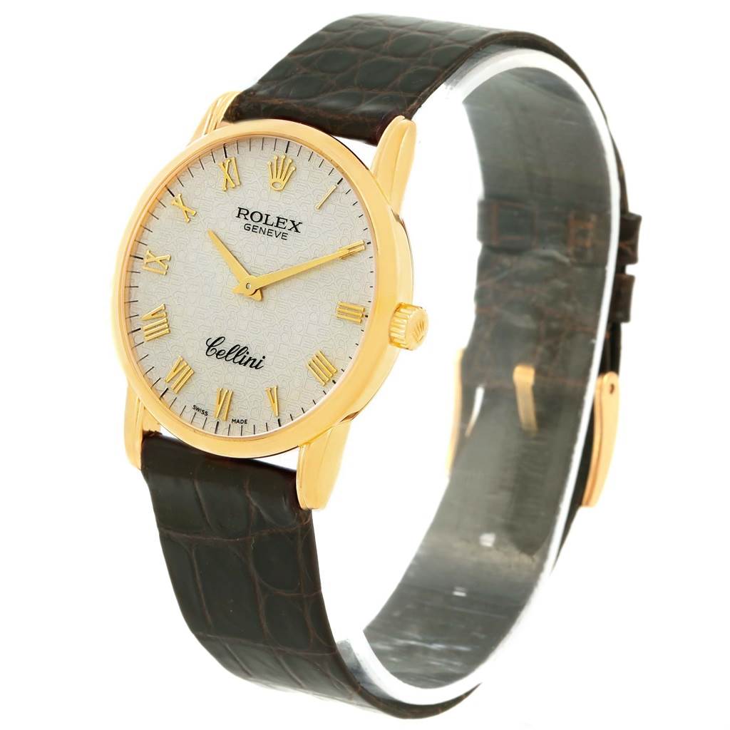 The Rolex Cellini 5116 Men's Yellow Gold Beige Dial 5116 Men's Yellow Gold Beige Dial watch is shown from an angled front view, highlighting its gold case, white dial, Roman numerals, and leather strap.