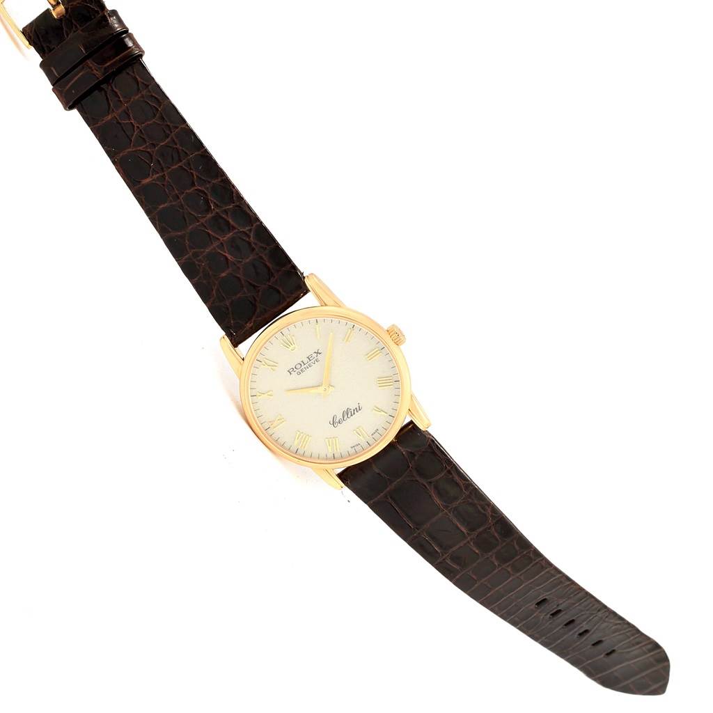 The Rolex Cellini 5116 Men's Yellow Gold Beige Dial 5116 Men's Yellow Gold Beige Dial watch is shown from a top view, highlighting the face, straps, and buckle.