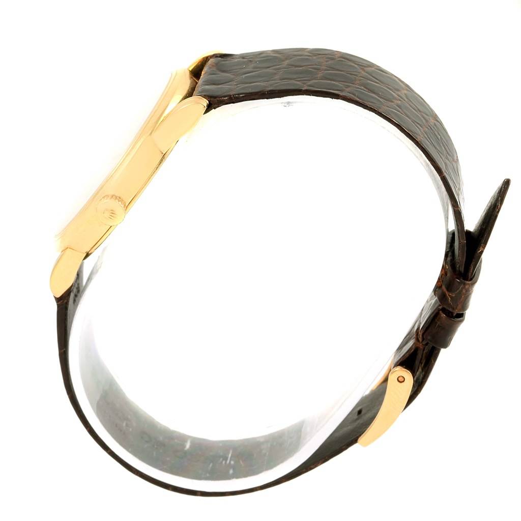 The image shows a side view of the Rolex Cellini 5116 Men's Yellow Gold Beige Dial 5116 Men's Yellow Gold Beige Dial watch, highlighting its gold case and brown leather strap.