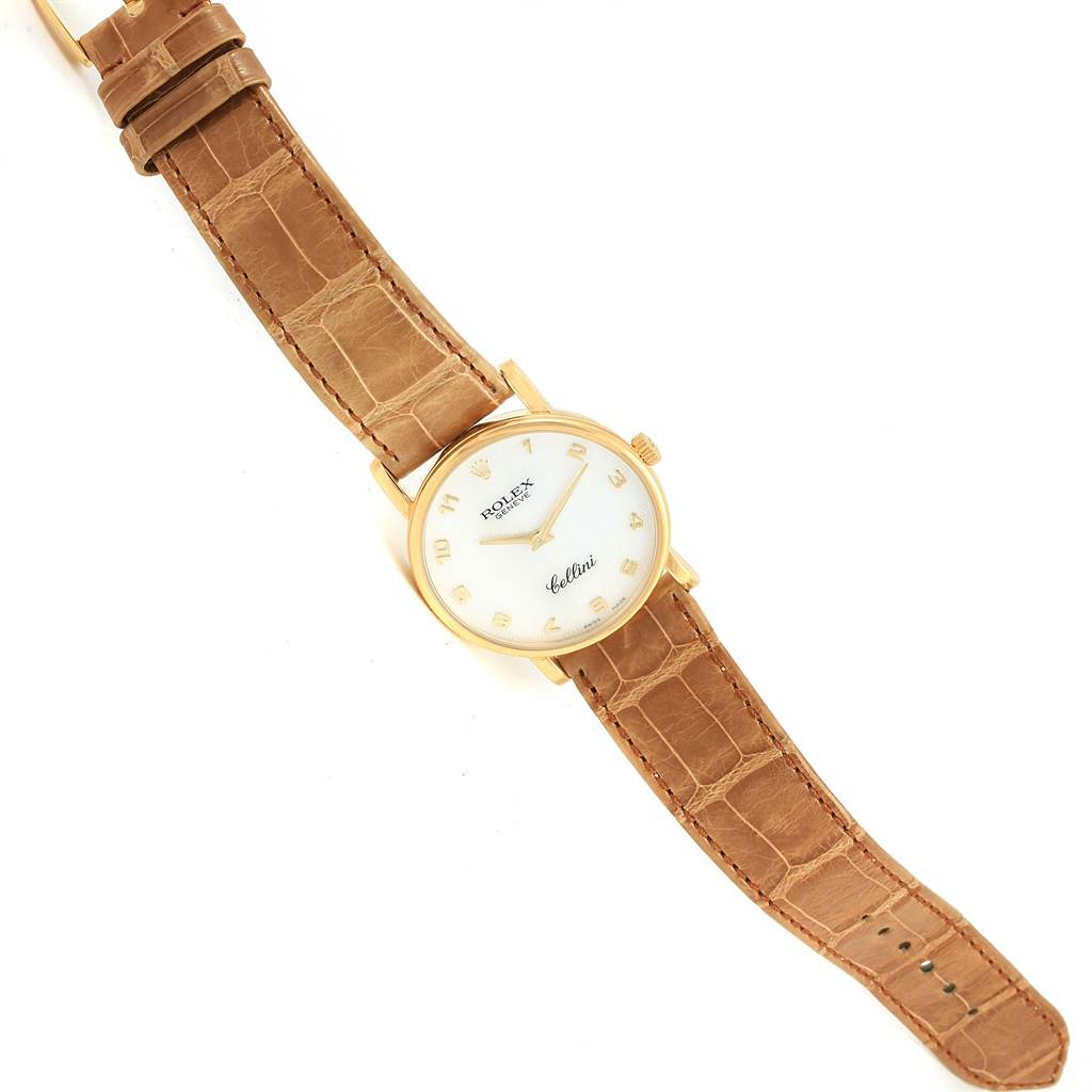 The image shows a Rolex Cellini 5115 Yellow Gold Mother of Pearl Dial 5115 Yellow Gold Mother of Pearl Dial watch at a top-down angle, highlighting its brown leather strap and round gold case.