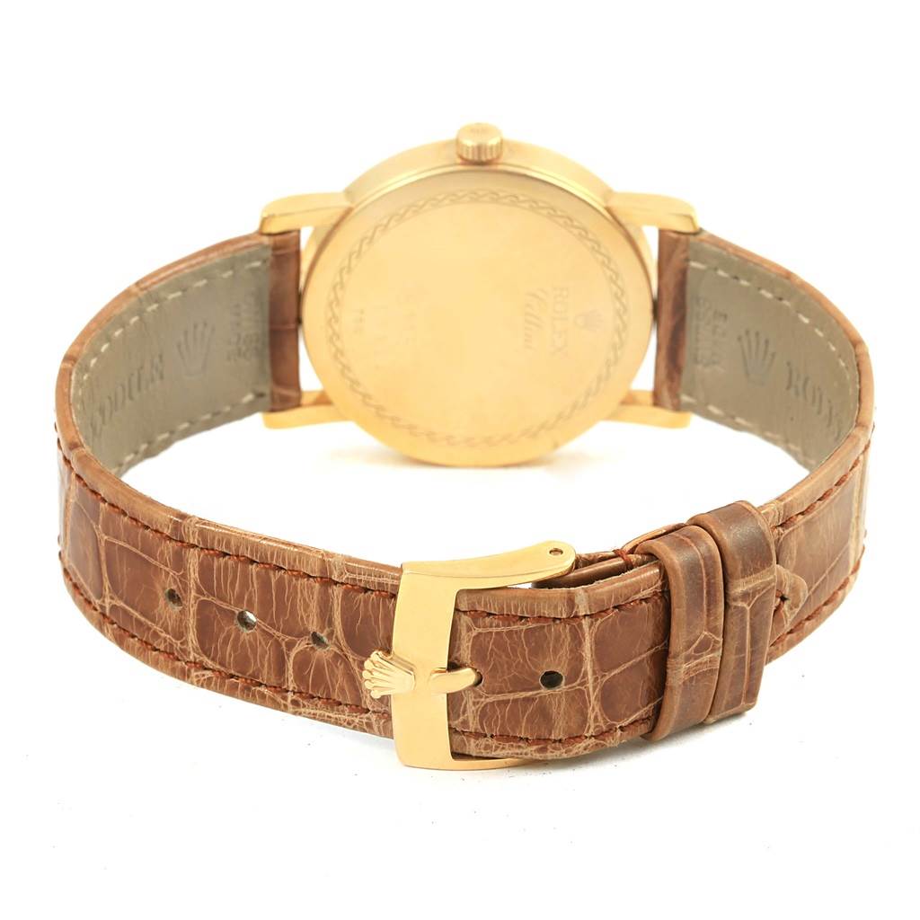 The image shows the back view of a Rolex Cellini 5115 Yellow Gold Mother of Pearl Dial 5115 Yellow Gold Mother of Pearl Dial watch, highlighting the gold case and brown leather strap with a gold buckle.