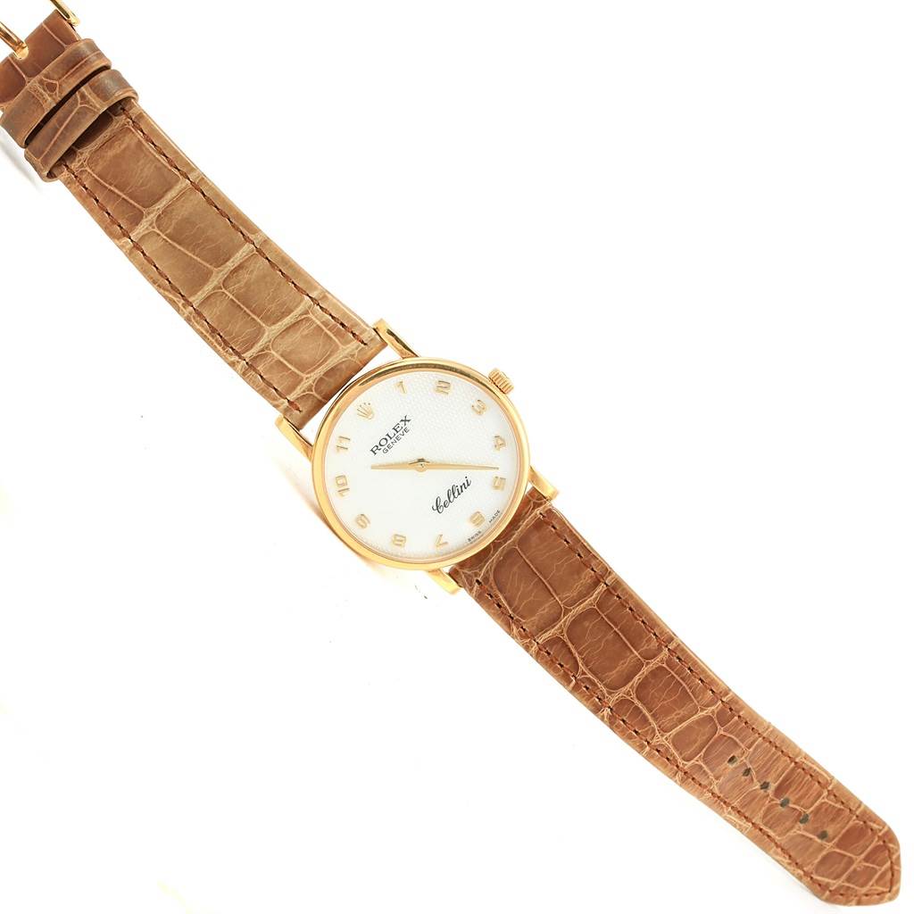 This image shows a Rolex Cellini 5115 Yellow Gold Mother of Pearl Dial 5115 Yellow Gold Mother of Pearl Dial watch from a top-down angle displaying its face, crown, and brown leather strap.