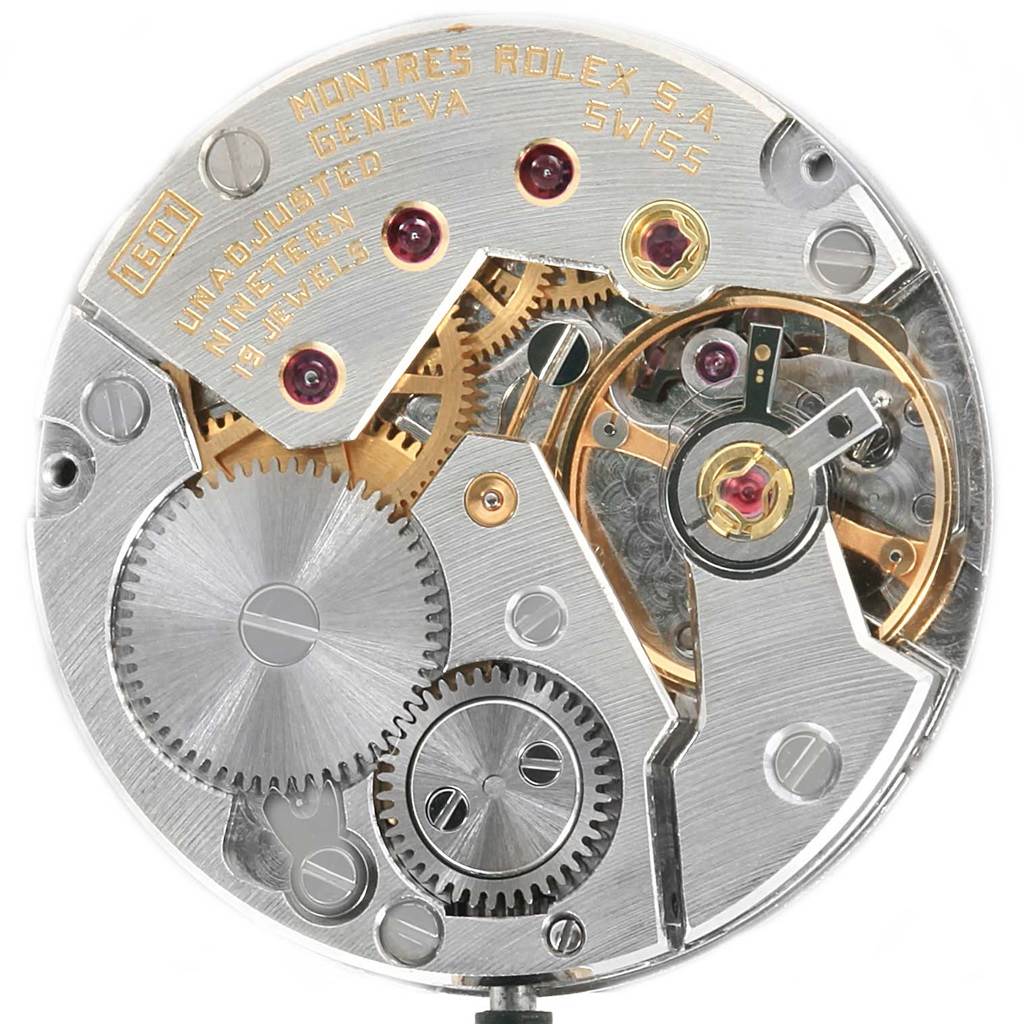This image shows the intricate internal mechanism of a Rolex Cellini 4127 Men's Yellow Gold Silver Dial 4127 Men's Yellow Gold Silver Dial watch, featuring gears, jewels, and inscriptions.