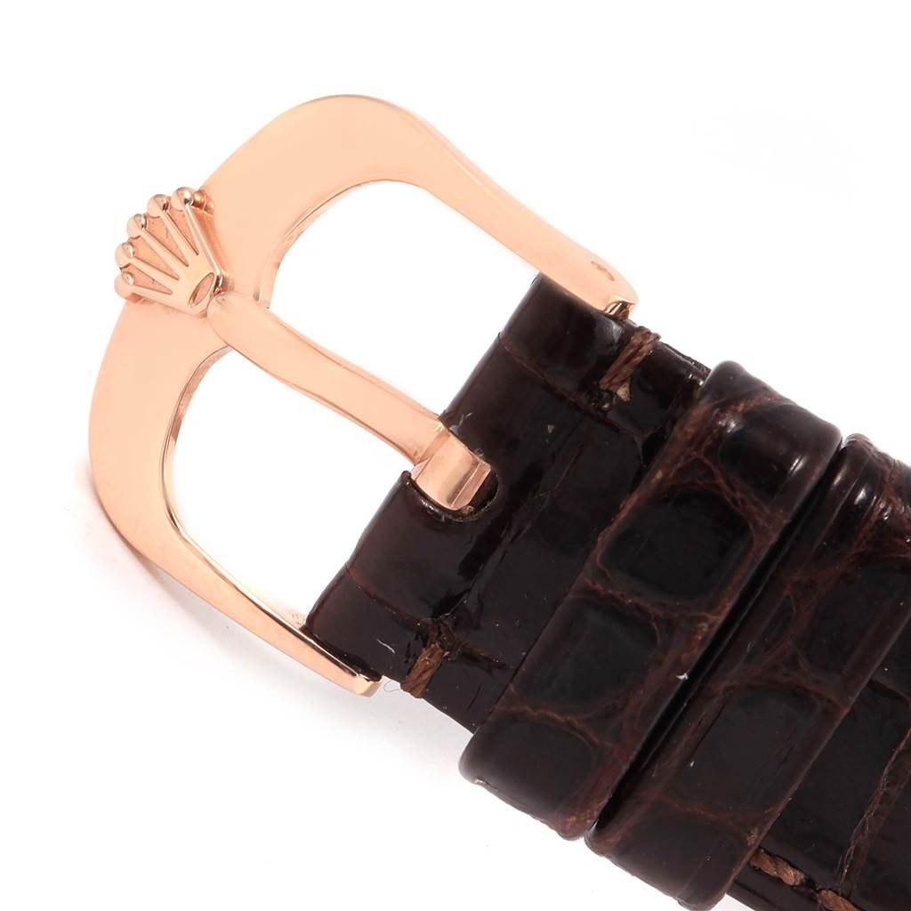 This image shows a close-up of the gold buckle and leather strap of a Rolex Cellini 50515 Men's Rose Gold Silver Dial 50515 Men's Rose Gold Silver Dial watch.