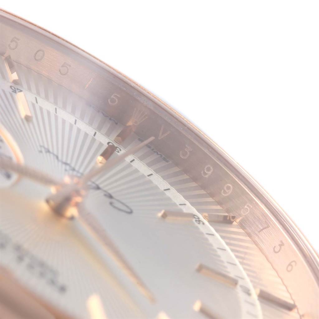 This close-up image of a Rolex Cellini 50515 Men's Rose Gold Silver Dial 50515 Men's Rose Gold Silver Dial model watch shows part of the dial, hands, and the edge of the bezel.