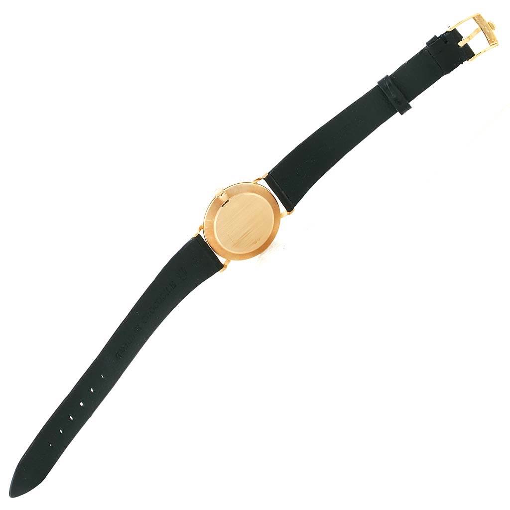 The image shows the back view of a Rolex Cellini 5112 Men
s Beige Dial 5112 Men
s Beige Dial watch, highlighting the watch case and black leather strap.